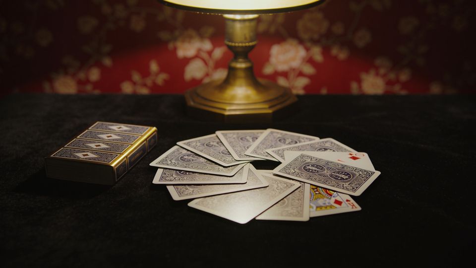 Go Fish on the W.F.A. deck, on black velvet under a brass lamp