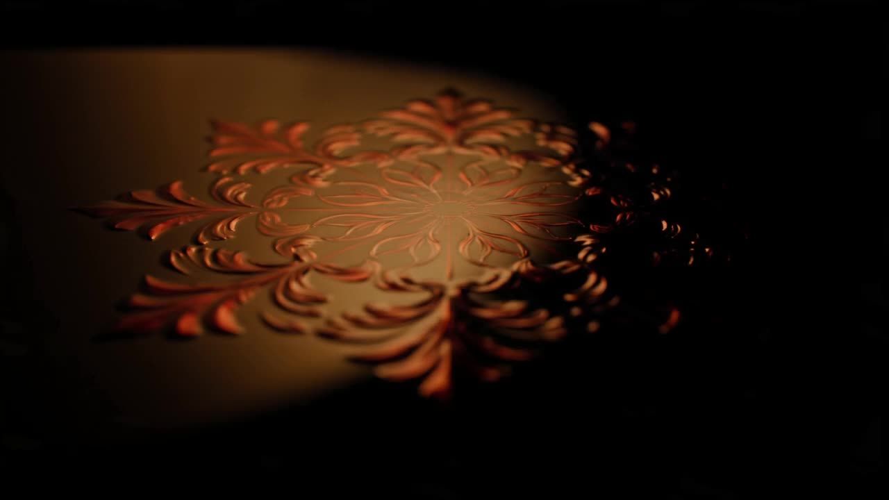 Warm light sweeping across the red floral relief